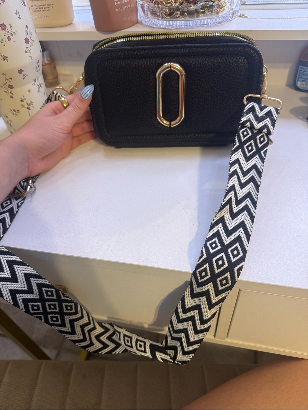 Black Crossbody Camera Bag with Gold Hardware and Patterned Strap